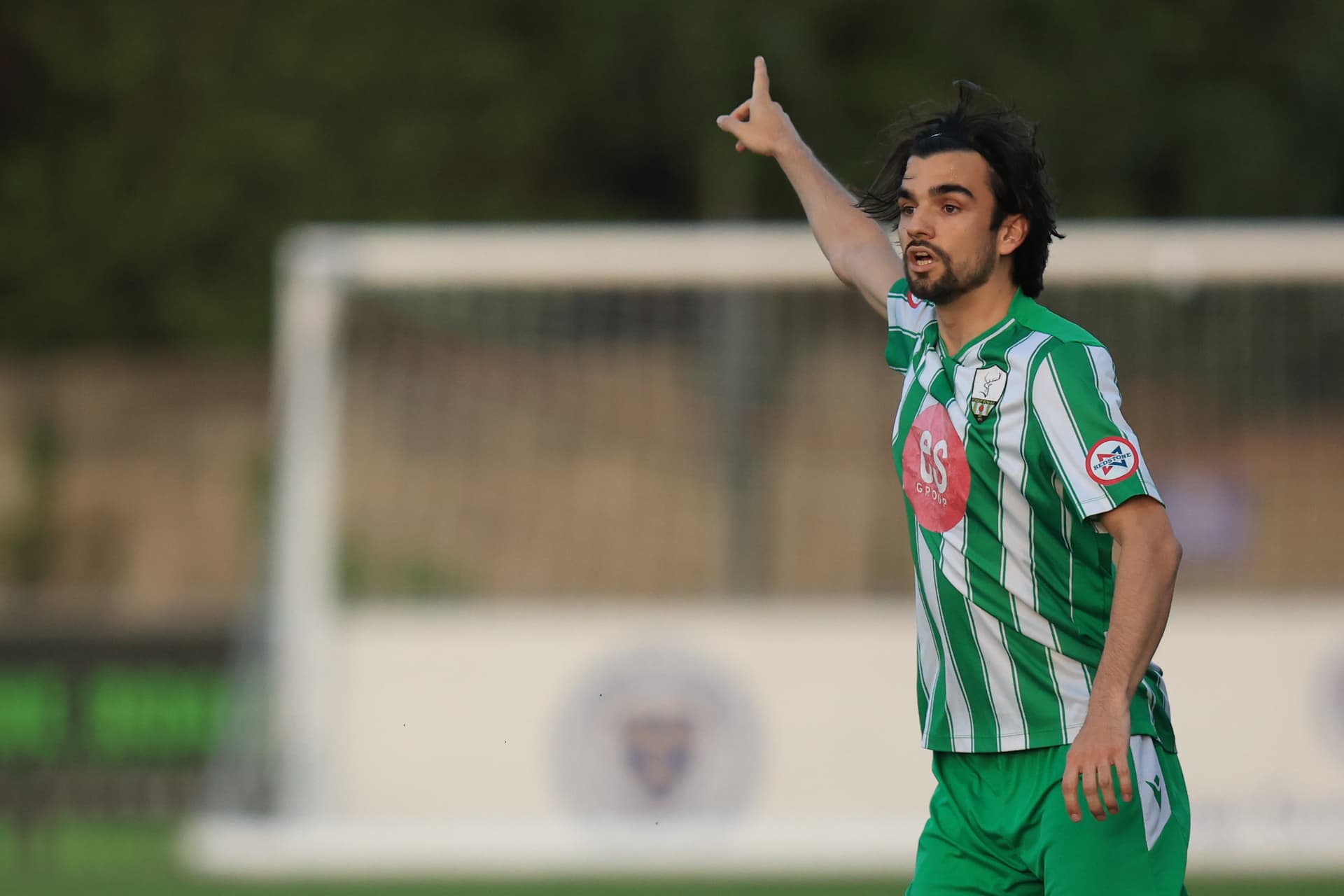 A Reserves player salutes the crowd after scoring