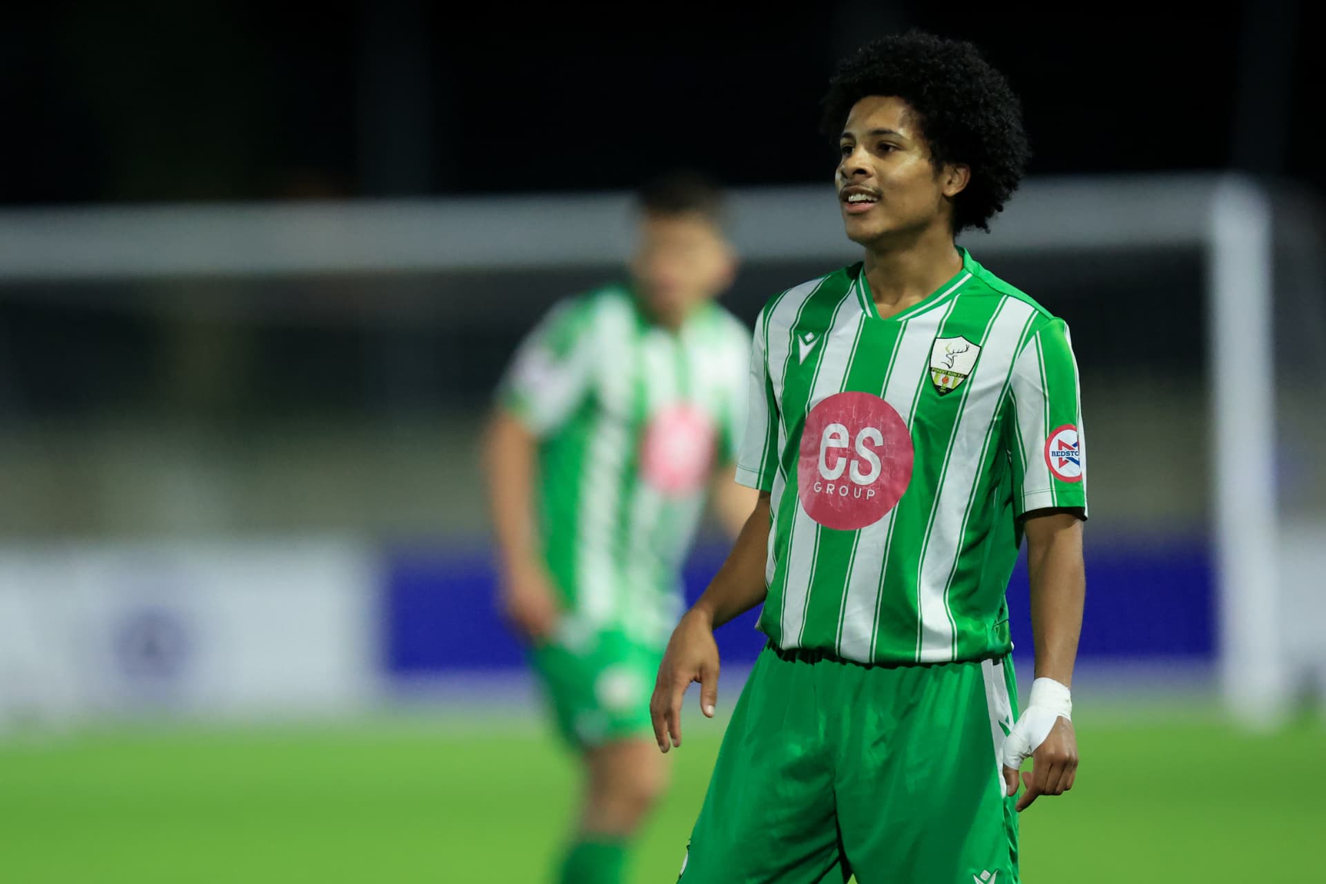A Forest Row player in the green and white stripes