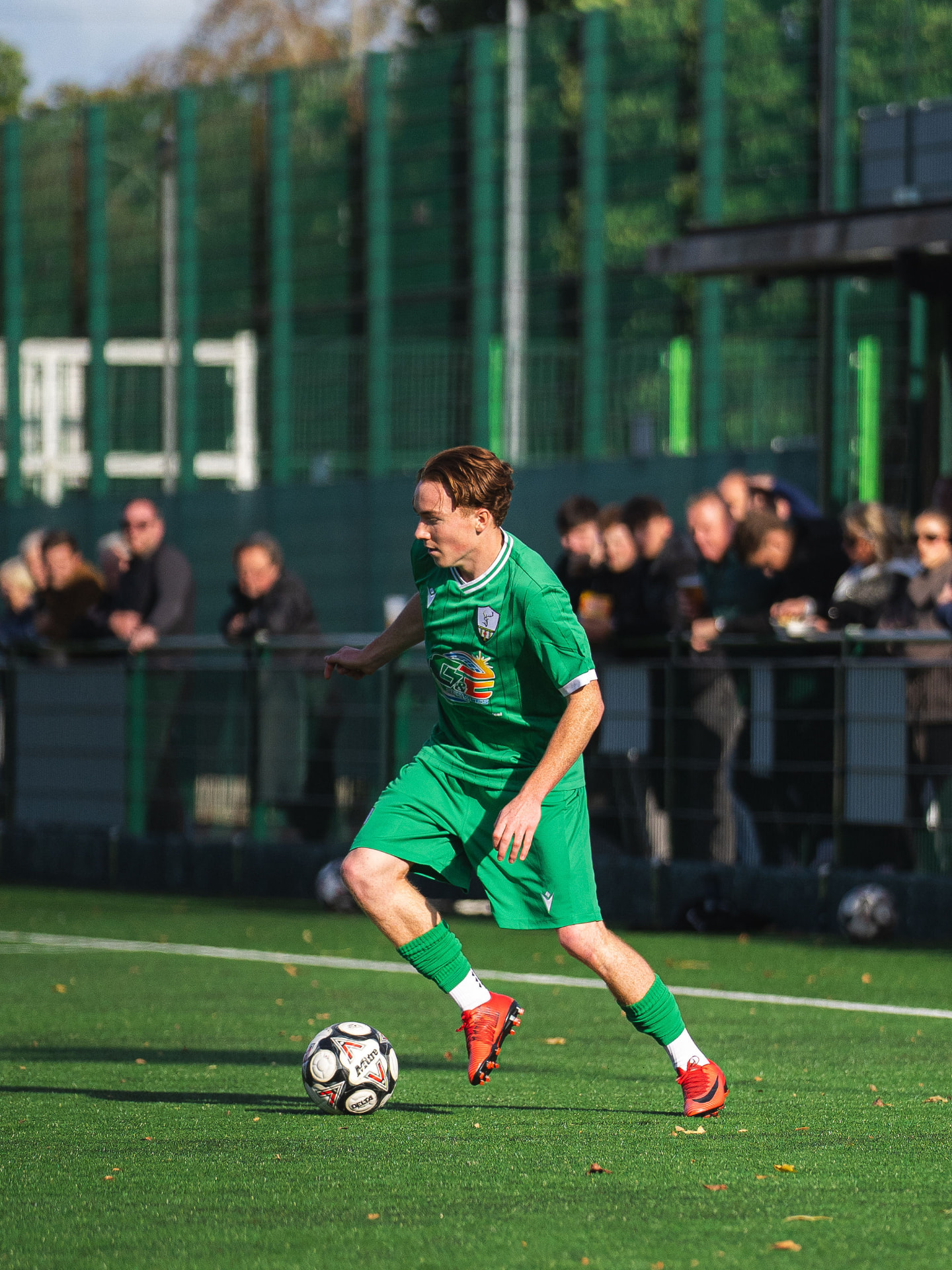 Forest Row player dribbling in front of the crowd